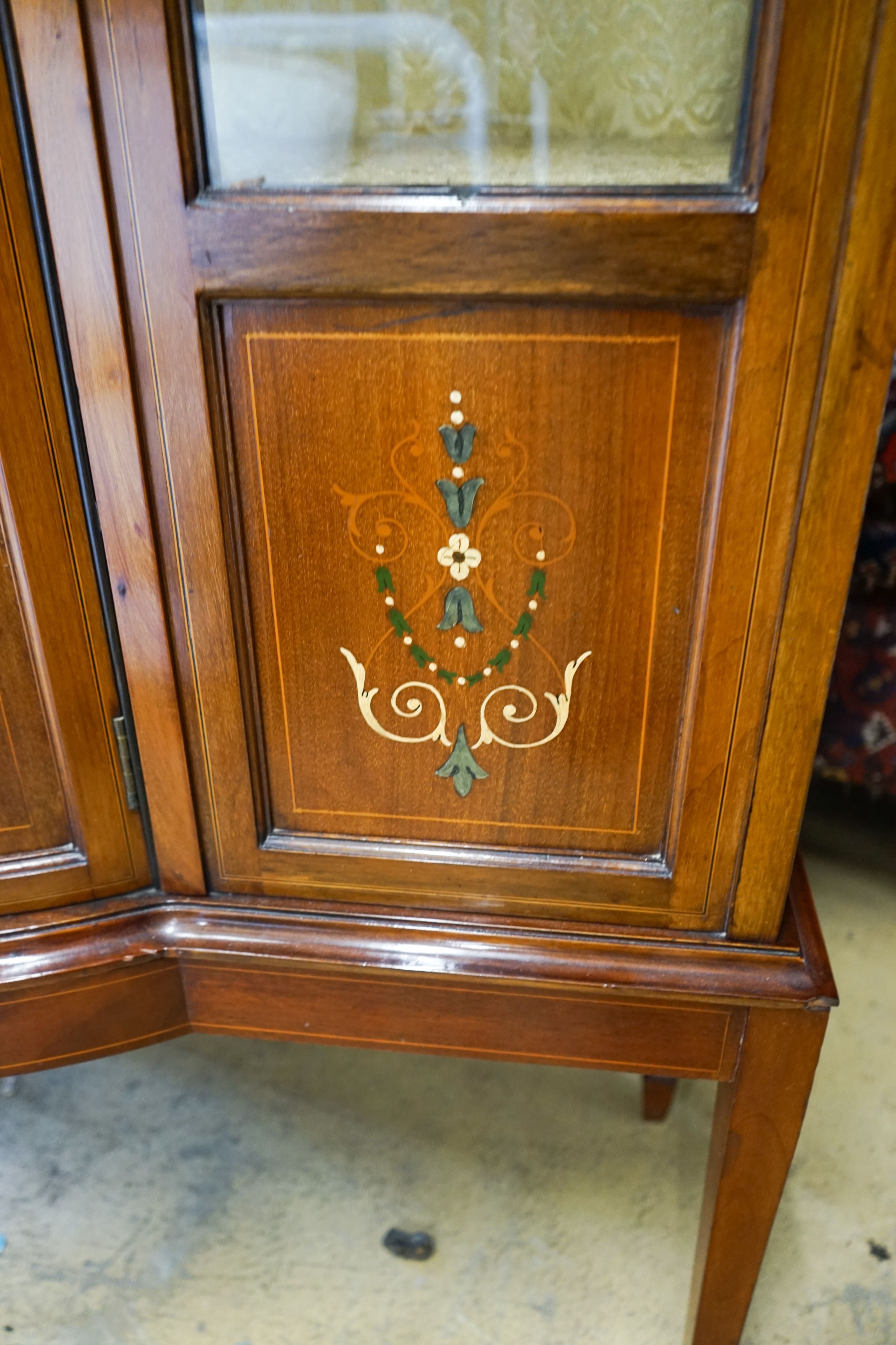 An Edwardian inlaid mahogany bow front display cabinet, width 115cm, depth 43cm, height 178cm